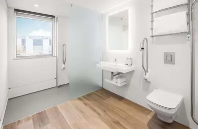 a white bathroom with a toilet and a sink at YOTEL Edinburgh in Edinburgh