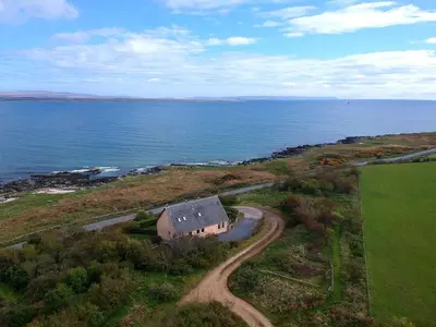 an aerial view of a house by the ocean at Shorefield, Bruichladdich in Bruichladdich