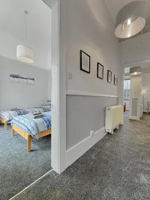 a bedroom with two beds in a room at Hayfield Apartment in Oban