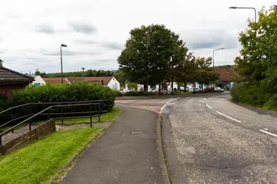 an empty road in a residential neighborhood with houses at Livingston Lodge Hotel in Livingston