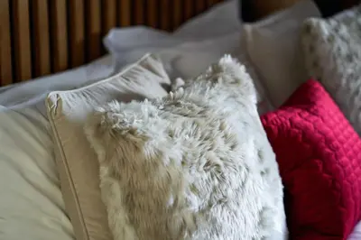 a bed with white and pink pillows on it at Thornhill Lodge, Historic 4 Bed, 4 Ensuite in Stirling