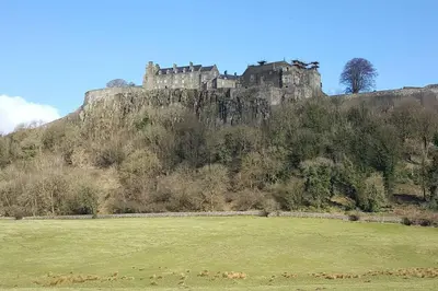 a castle on top of a hill with a field at Stuc an t Sagairt Cottage , Loch Lomond in Drymen