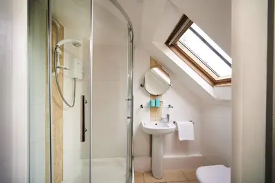a bathroom with a shower and a sink at Stuc an t Sagairt Cottage , Loch Lomond in Drymen