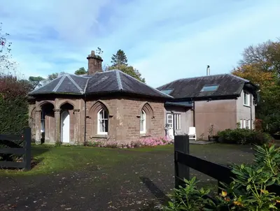 an old brick house with a black roof at North Lodge of Orchil in Braco