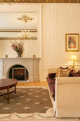 a living room with a fireplace and a couch at Grand in the Park in Glasgow