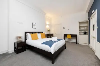 a bedroom with a bed and a desk in it at JOIVY Haymarket in Edinburgh
