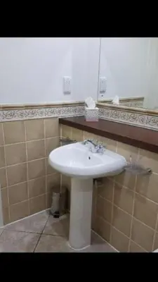 a bathroom with a white sink and a mirror at Luxury 2Bedroom Lodge in Auchterarder