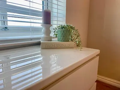 a candle and a plant sitting on a window sill at Kintyre Apartment in Ayr