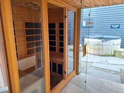 a glass door of a house with a patio at Lochend Chalets in Port of Menteith