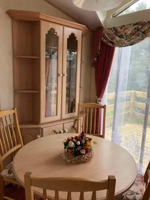 a dining room table with a bowl of flowers on it at Lyndhurst 28 in Dunoon