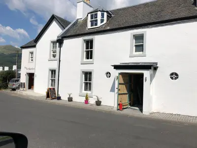 a white building on the side of a street at Lyndhurst 28 in Dunoon