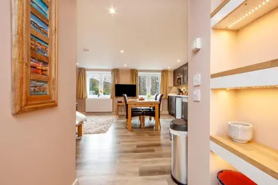 a kitchen and dining room with a table and a dining room at Mandarin Premier Apartments C - studio apt in Oban