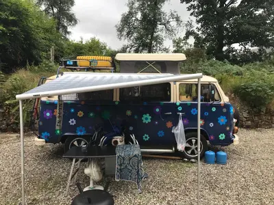 a blue van with a canopy on top of it at The West Highland Way Campsite & Campervan Accommodation in Milngavie