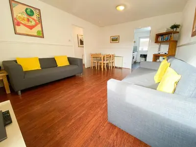 a living room with a couch and a table at Glasgow Green Park Home in Glasgow