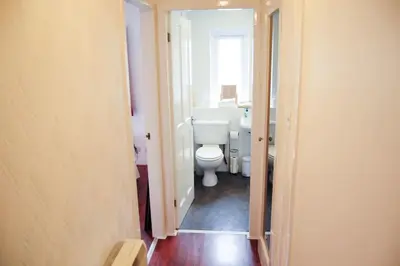 a bathroom with a white toilet and a sink at Glasgow Green Park Home in Glasgow