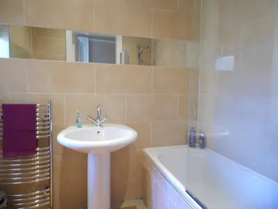 a bathroom with a sink and a bath tub at WEST END - Stunning, spacious, 3 bedroom, main door flat with private parking in Glasgow