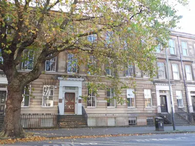 a large building with a tree in front of it at WEST END - Stunning, spacious, 3 bedroom, main door flat with private parking in Glasgow