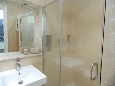 a bathroom with a glass shower with a sink at WEST END - Stunning, spacious, 3 bedroom, main door flat with private parking in Glasgow