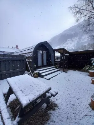 a snow covered yard with a gazebo at Coe Pod, West Highland Way Holidays in Kinlochleven