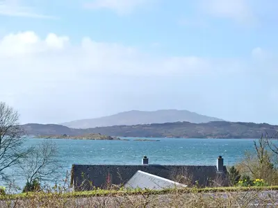 a view of a body of water with mountains in the background at Tigh An Aighear in Arduaine