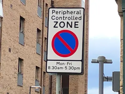 a no parking sign in front of a building at Haymarket Spacious 3 Bedroom Street Level in Edinburgh