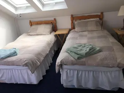 two beds sitting next to each other in a room at Beach Front Flat, Brodick in Brodick