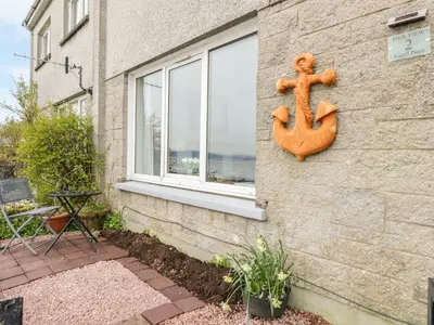a wooden anchor on the side of a building at Pier View in Dunoon
