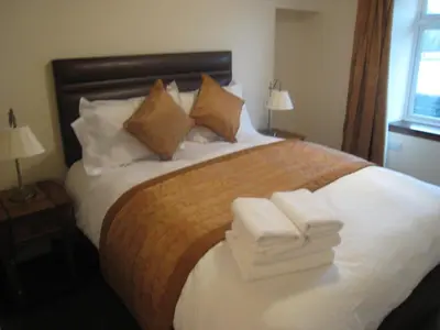 a hotel room with a bed with towels on it at Leny Estate in Callander