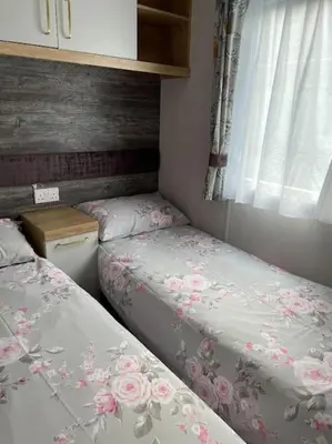 a bedroom with two beds and a window at Swift Bordeaux Sea View 15 in Dunoon