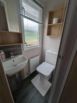 a small bathroom with a toilet and a sink at Swift Bordeaux Sea View 15 in Dunoon