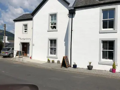 a white building with a sign in front of it at Swift Bordeaux Sea View 15 in Dunoon