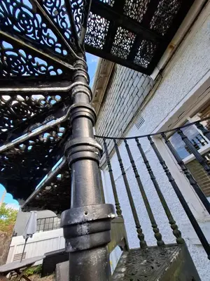 a metal pole in front of a building at Black Stair Room - En Suite in Helensburgh