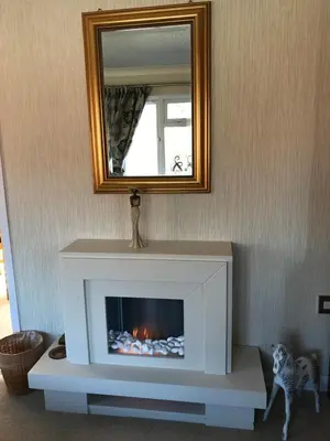 a fireplace in a living room with a mirror at Grandeagles Extra large lodge in Auchterarder