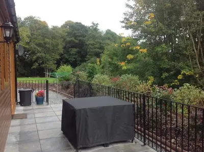 a table with a black cover on a fence at Grandeagles Extra large lodge in Auchterarder