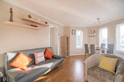 a living room with a couch and a table at The Cluthar - Ground Floor West End City Centre Rockvilla flat & Parking in Glasgow