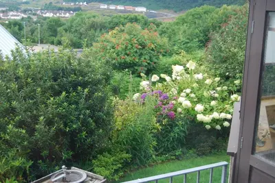 a view of a garden with flowers on a balcony at Skerryvore in Oban