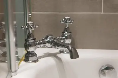 a bathroom sink with a silver faucet at Frederick Street - stylish apartment in the heart of New Town! in Edinburgh
