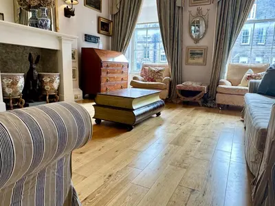 a living room with a couch and a table at Frederick Street - stylish apartment in the heart of New Town! in Edinburgh