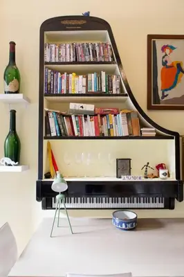 a book shelf with a piano in a living room at Frederick Street - stylish apartment in the heart of New Town! in Edinburgh