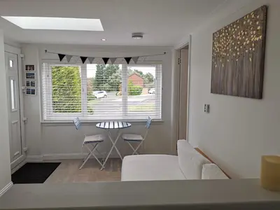 a living room with a couch and a table and a window at Executive Annex - Dunfermline in Dunfermline