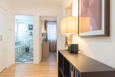 a kitchen with a counter top and a bathroom at Merchant City Glasgow Green Apartment With Parking in Glasgow
