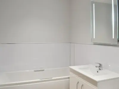 a white bathroom with a sink and a mirror at Smithfield House in Tarbolton