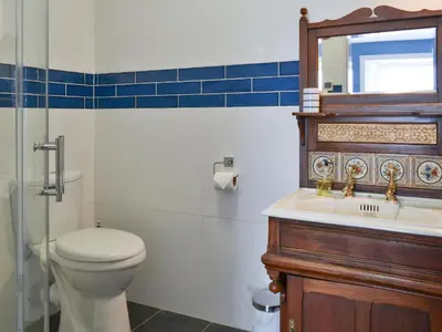 a bathroom with a toilet and a sink and a mirror at Fircliff - The House On Bute in Port Bannatyne