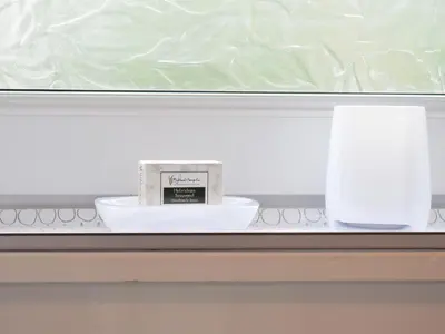 a counter with a bowl and a candle on it at Finlaggan Apartment in Oban