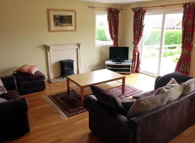 a living room with a couch and a table at Camus Bhan in Ballachulish