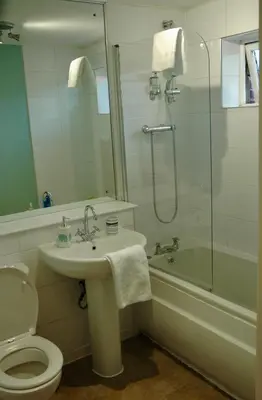 a bathroom with a toilet and a sink and a shower at The Socair - Bright Contemporary Merchant City Flat in Central Location in Glasgow