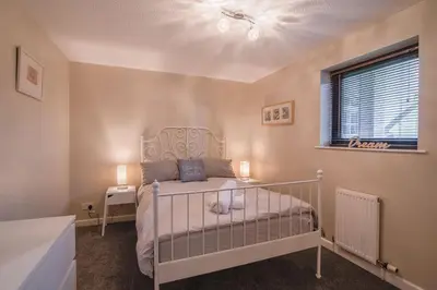 a bedroom with a white bed and a window at ArcView - SEC Hydro Two Bed Flat With Free parking and Great View in Glasgow