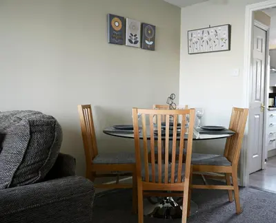 a dining room with a table and chairs at ArcView - SEC Hydro Two Bed Flat With Free parking and Great View in Glasgow