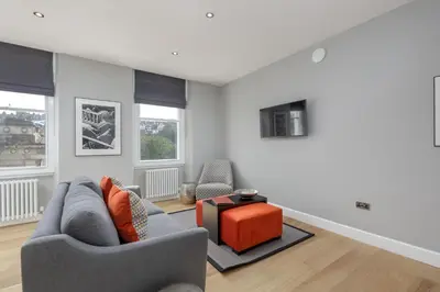 a living room with two chairs and a table at Destiny Scotland Hanover Apartments in Edinburgh