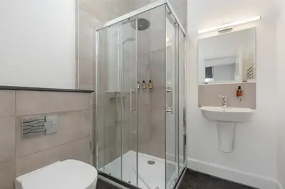 a bathroom with a shower and a toilet and a sink at Destiny Scotland Hanover Apartments in Edinburgh